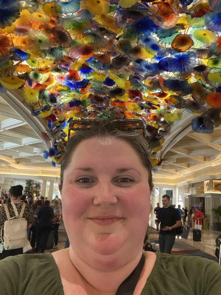 Lindsay Palmer in front of the Dale Chihuly ceiling at the Bellagio in Las Vegas, Nevada
